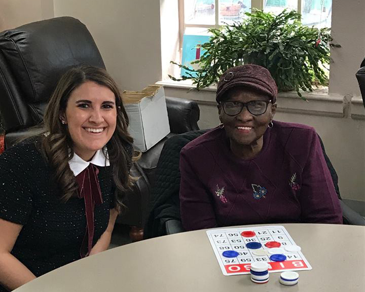 FRP lawyer Meredith Maitrejean playing bingo with a senior citizen