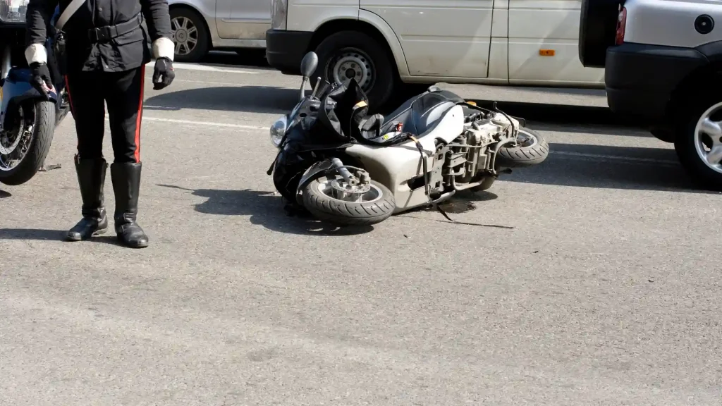 Motorcycle lying on its side after an accident on the road.