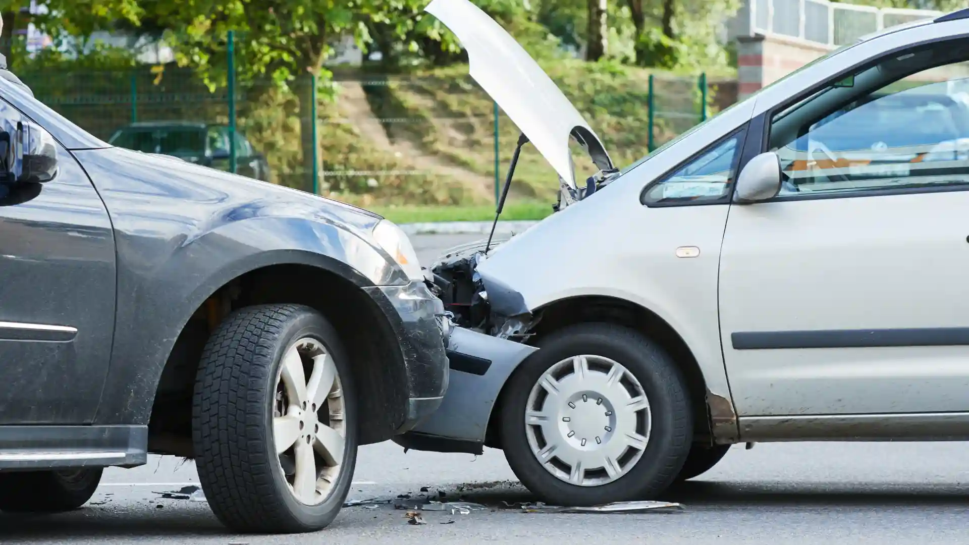 Two cars with front-end damage after a collision on the road